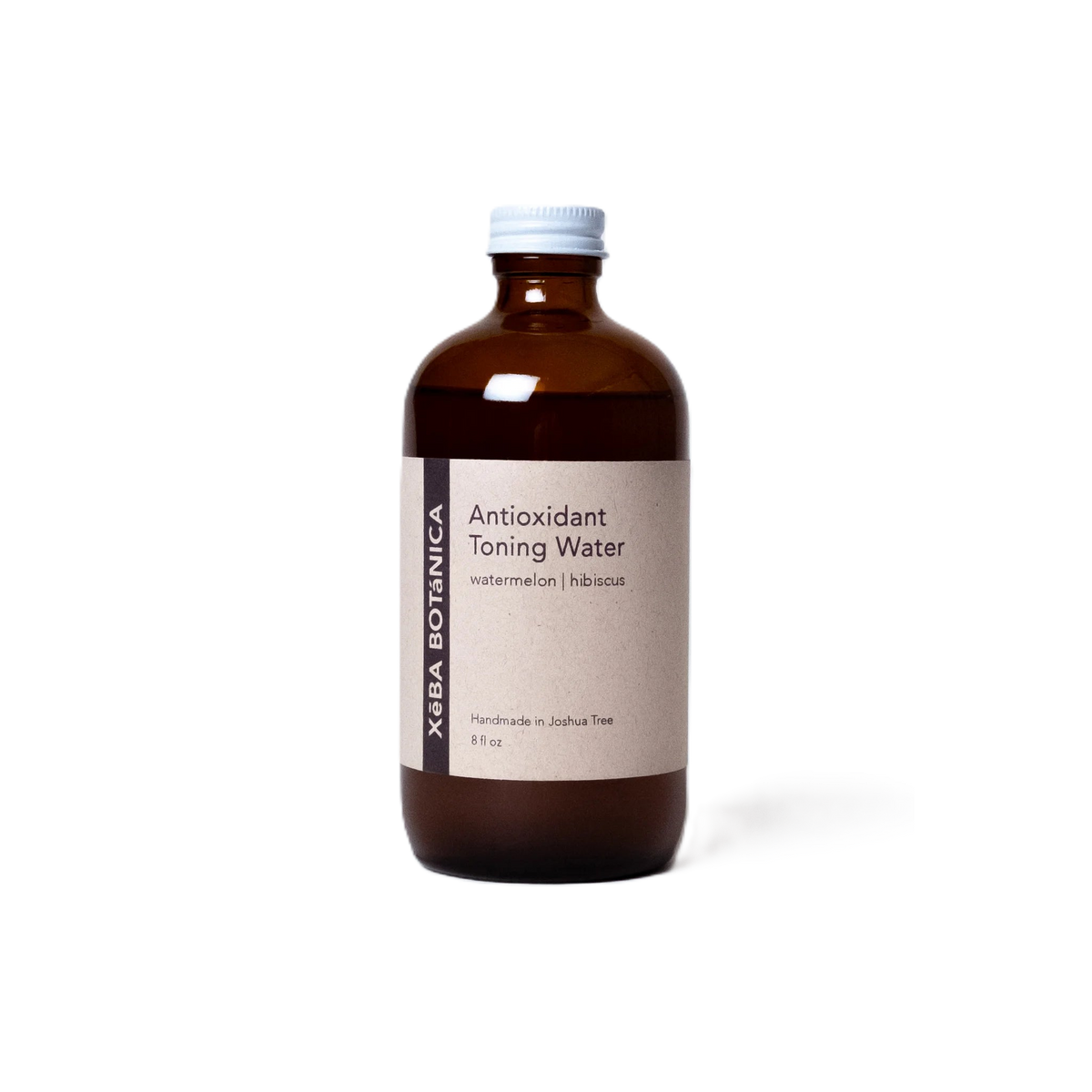 Amber glass bottle with a printed paper label