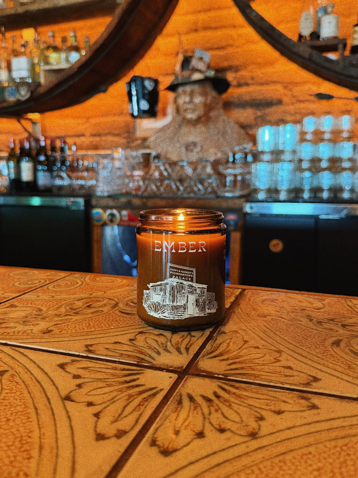 Ember candle burning on the tooled leather bar at Pappy & Harriet's Pioneertown Palace