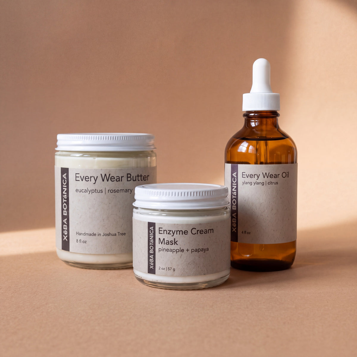 Enzyme Cream Mask with Every Wear Butter and Every Wear Oil on a warm clay backdrop