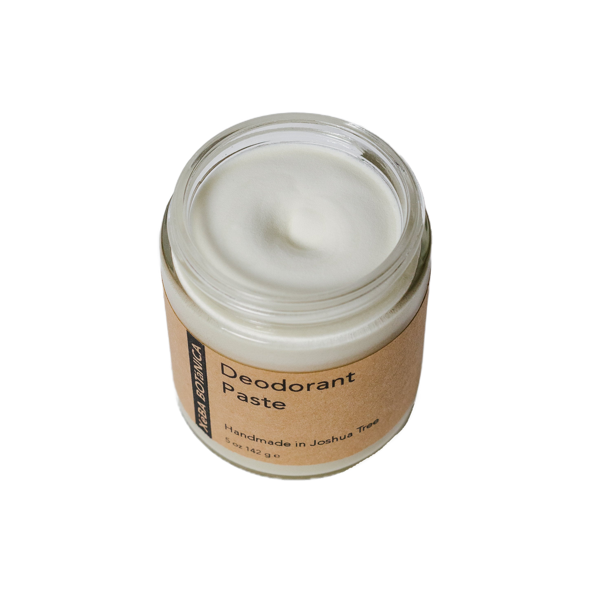 Frosted glass jar of paste on a grey backdrop