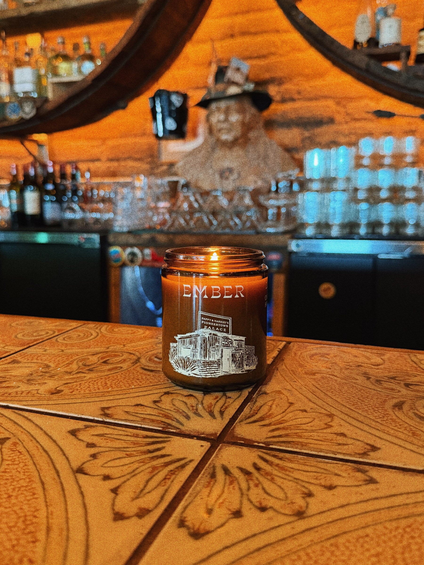 Ember candle burning on the tooled leather bar at Pappy & Harriet's Pioneertown Palace