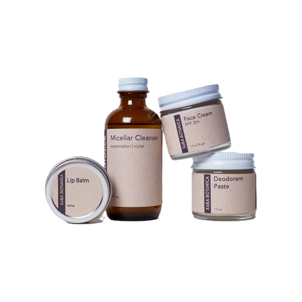 Three small jars and a bottle grouped together